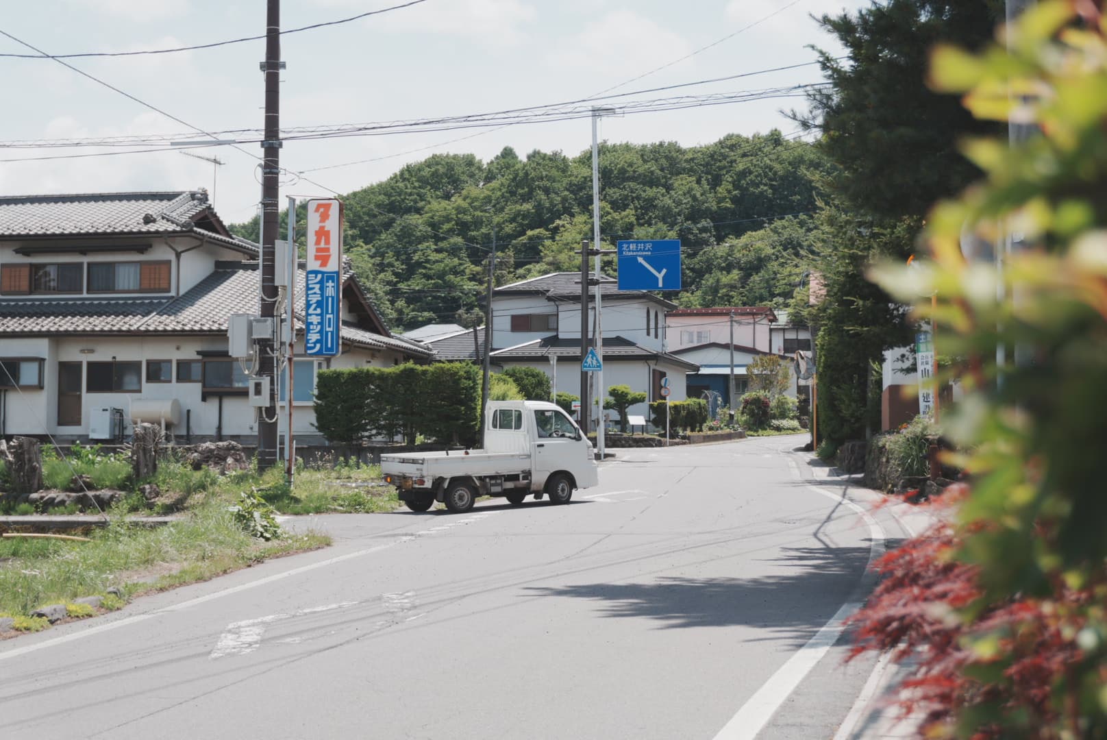 軽トラックが走る町並みの風景